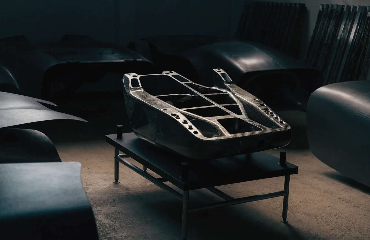 Close view of a bare carbon-titanium monocoque panel under a hard raking light